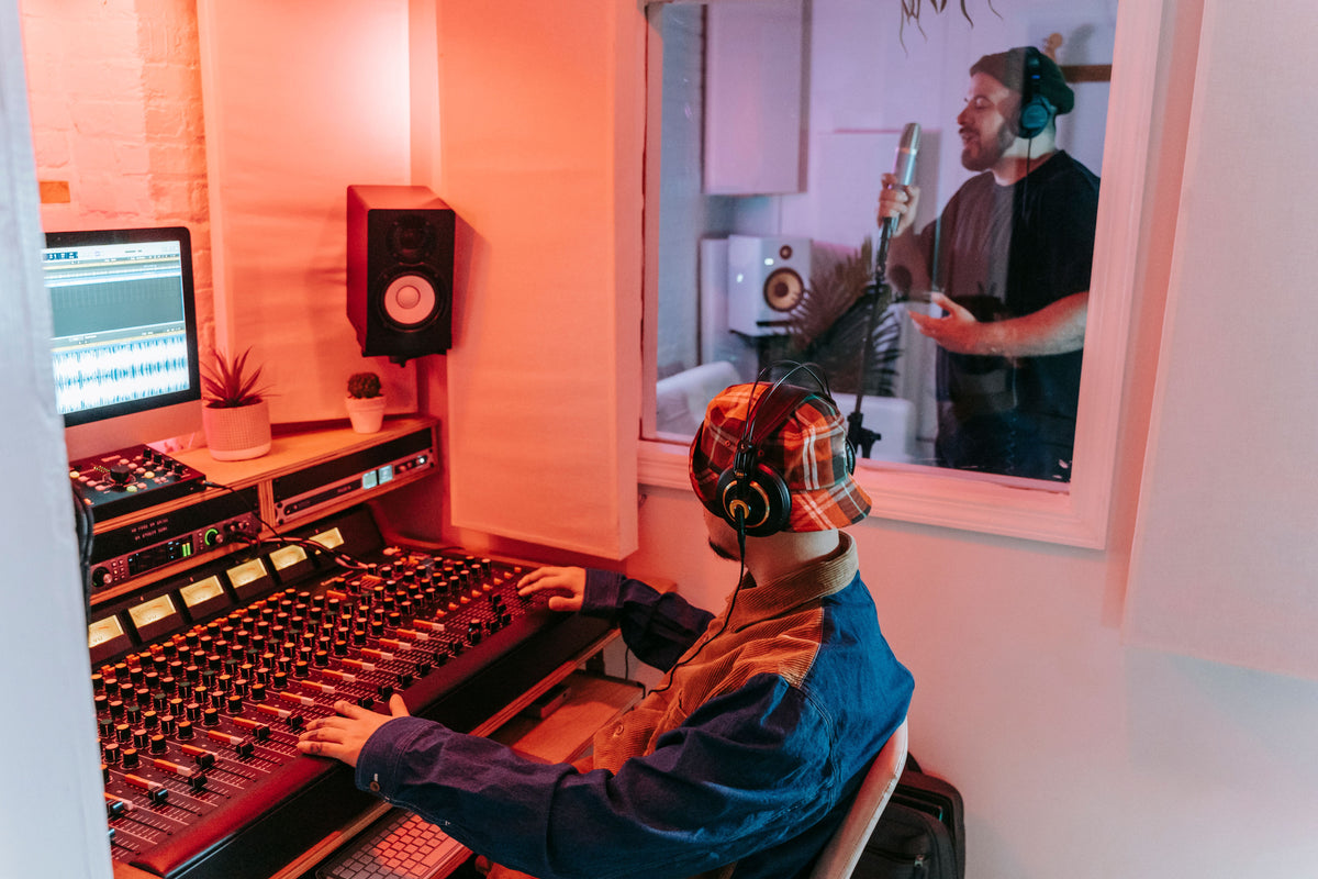 Artist performing emotionally at studio microphone without label backing
