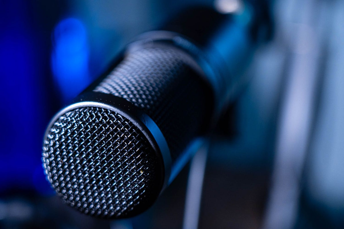 Vocalist recording with a microphone in a professional studio