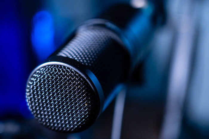Vocalist recording with a microphone in a professional studio