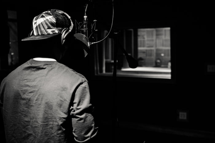 Artist recording in a dark professional recording studio