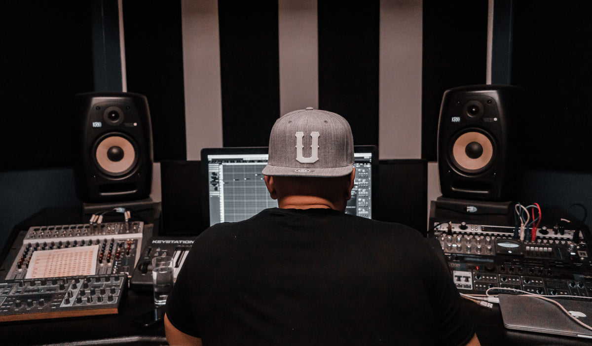 Music producer leaned back in studio chair thinking strategically