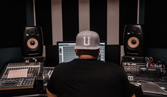 Music producer leaned back in studio chair thinking strategically