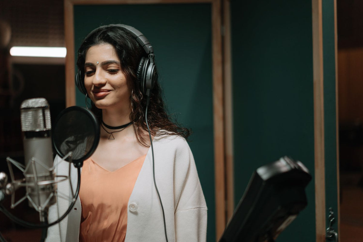 Singer in a recording booth choosing the right beat