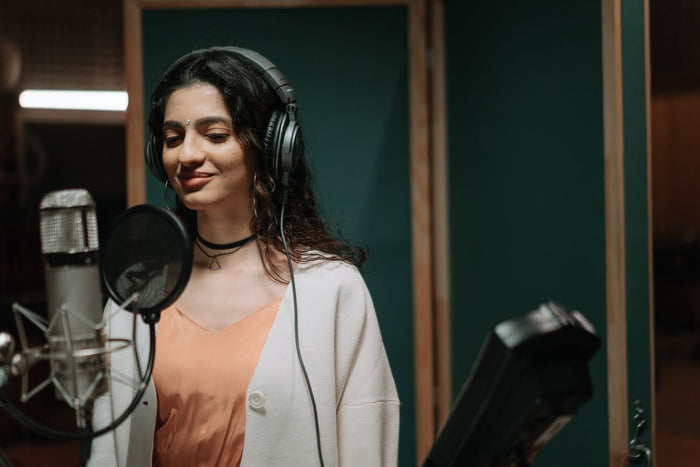 Singer in a recording booth choosing the right beat