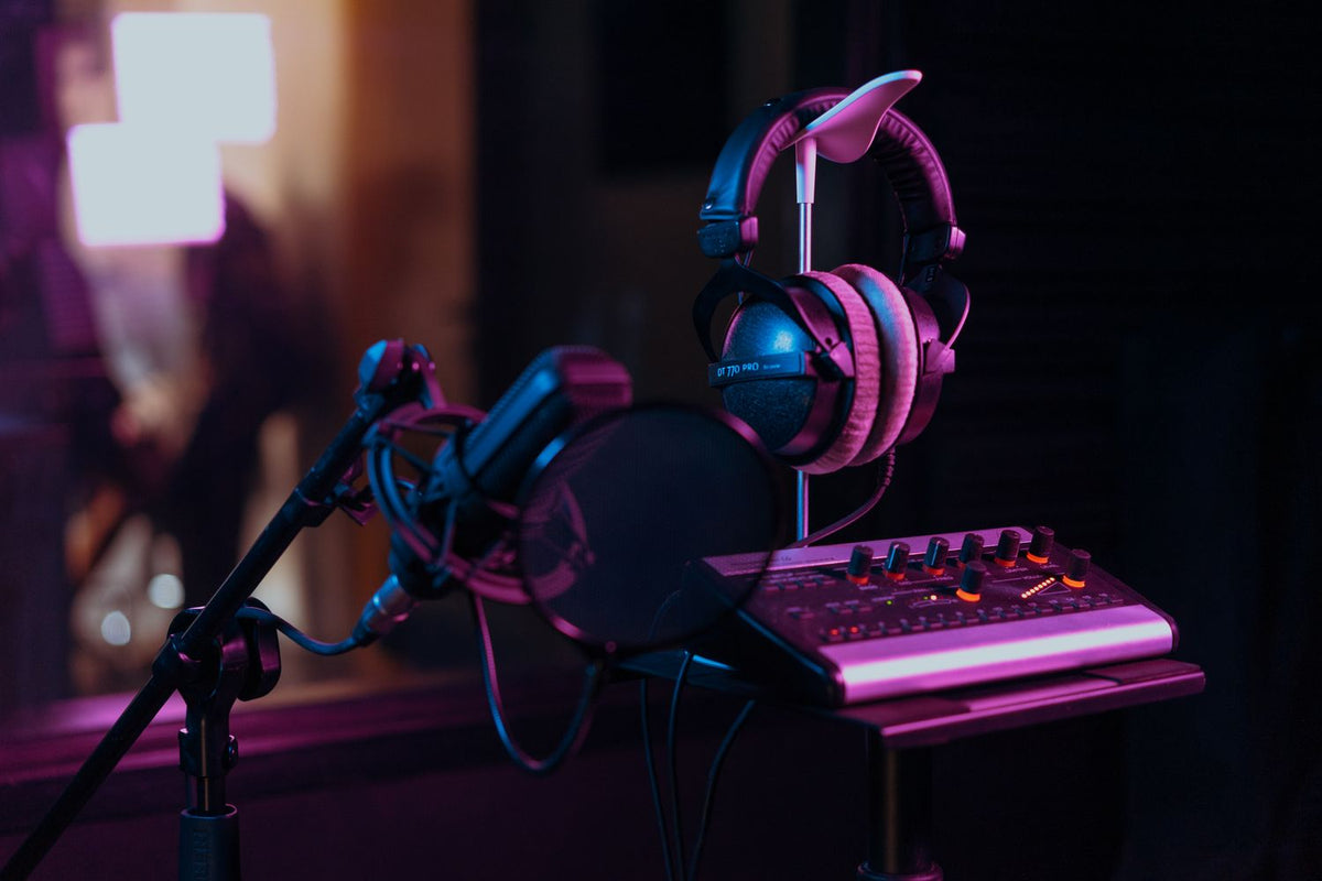 Producer mixing vocals with headphones in a home studio
