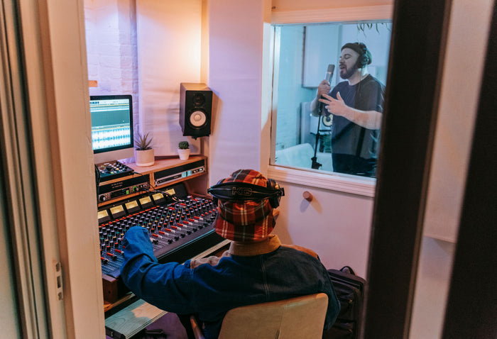 Producer at studio mixing board building a professional recording catalog