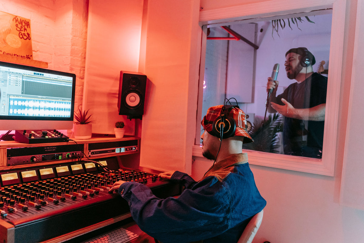 Artist recording in studio booth with determination and focus