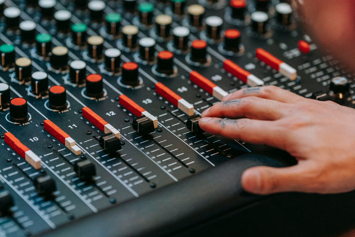 Music producer working at a studio mixing console