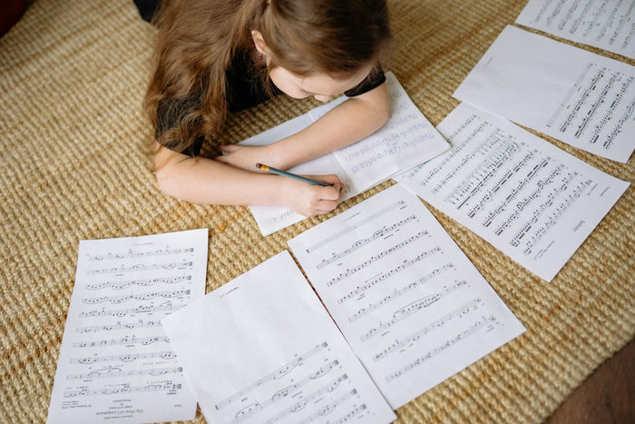 Sheet music and publishing contract on a desk